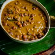 South Indian style brown chickpeas curry served in a beige bowl