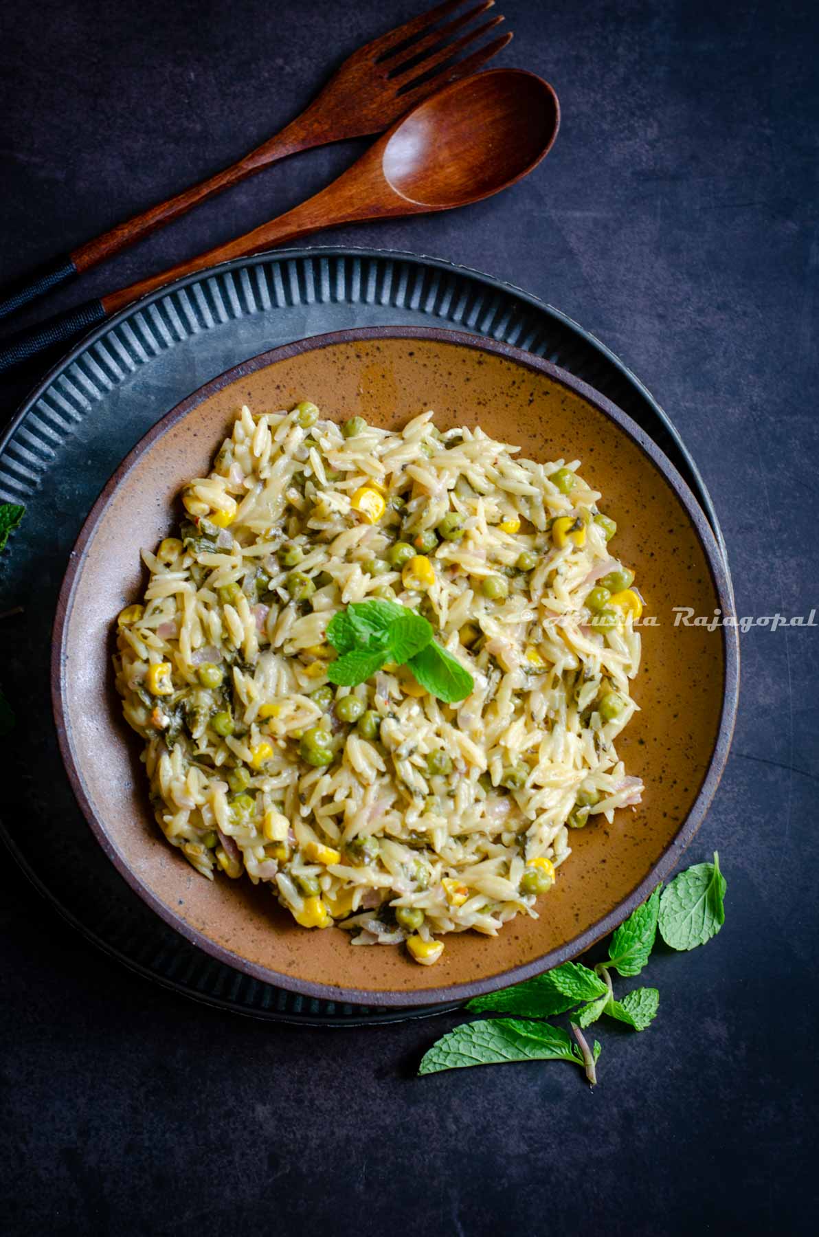 Creamy lemony Instant Pot orzo pasta served in a brown bowl.