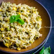 A close up of vegetable lemon orzo in a bowl.