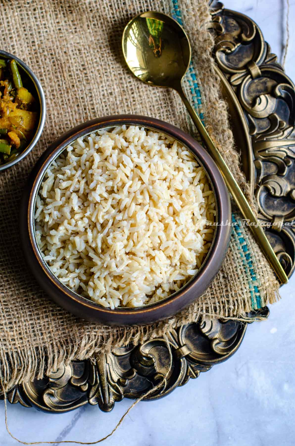 Instant pot brown basmati served in a black bowl on a rustic platter.